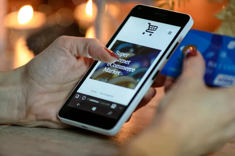 Person using smartphone for mobile payment and ecommerce order management in Indonesia