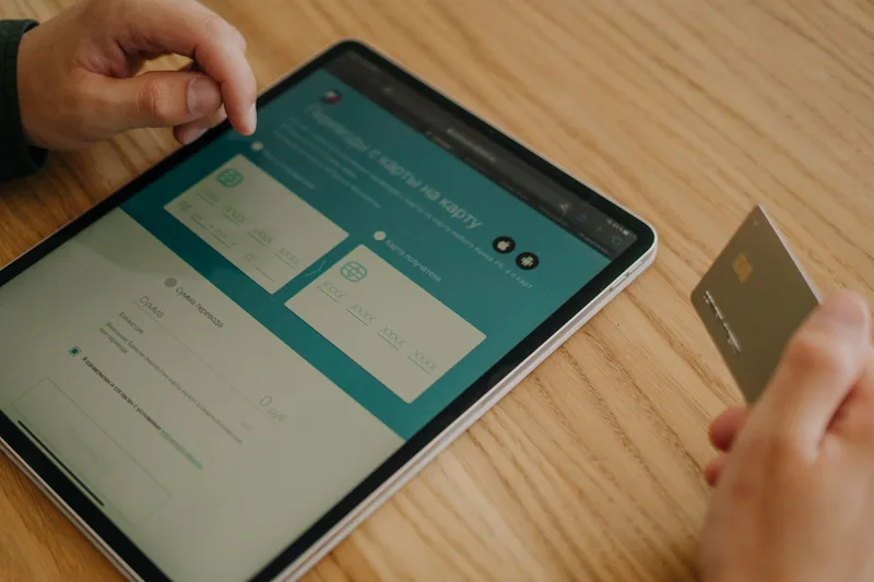 Ecommerce merchant analyzing BNPL payment method options on tablet with Indonesian product catalog and Rupiah payment data visible in background