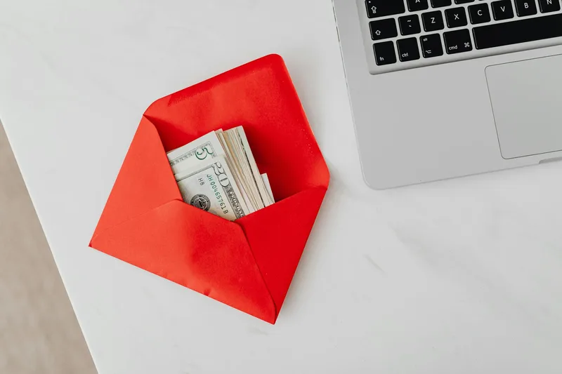 Bank settlement and payment payout illustration with envelope and laptop on desk