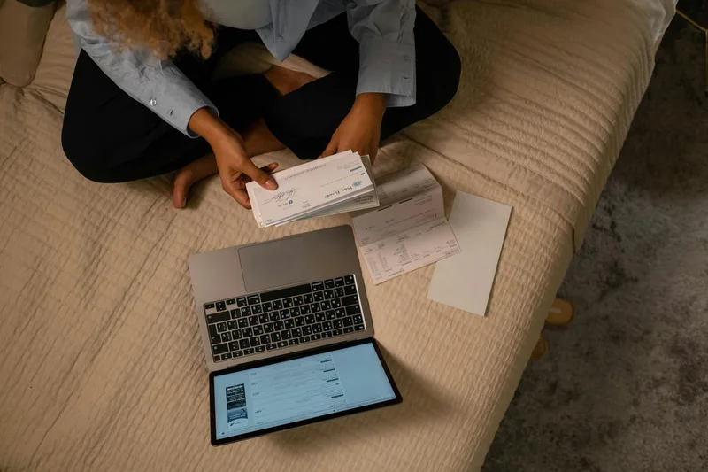 Business owner checking bank settlement dashboard on laptop